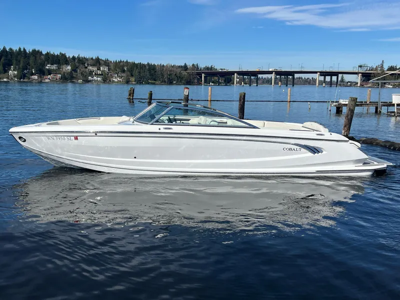 Slide: The Image of 2017 Cobalt A28 boat on calm lake with scenic background. - 1