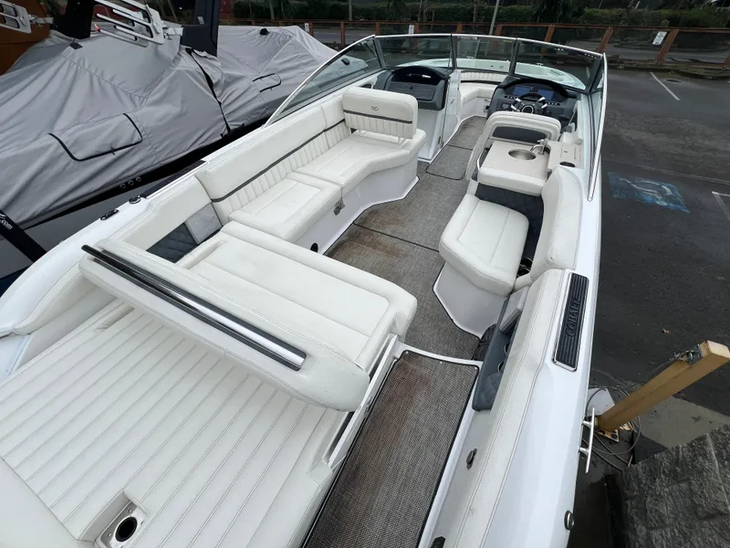 Slide: The Image of 2017 Cobalt A28 boat interior with white seating and modern dashboard. - 11