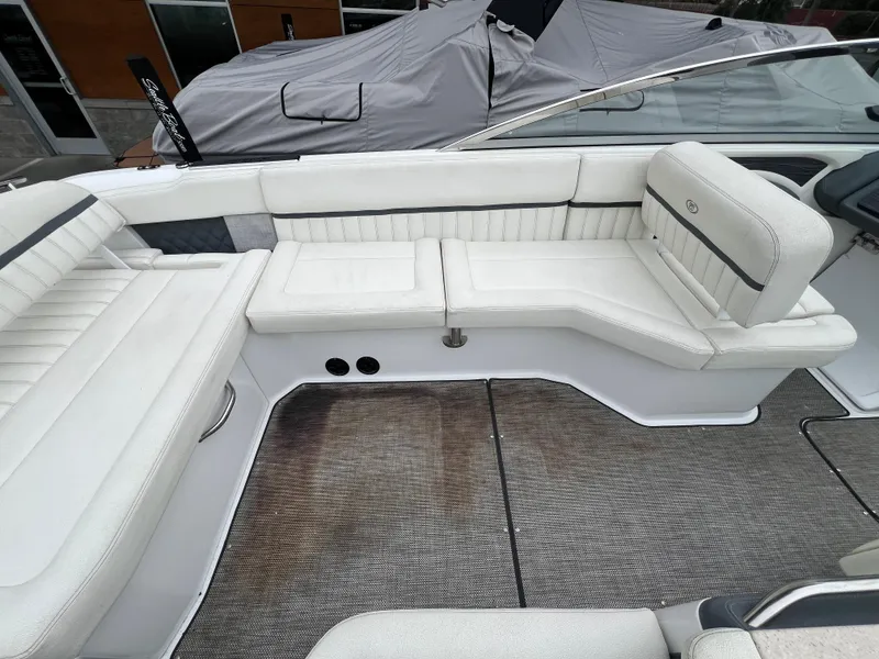 Slide: The Image of 2017 Cobalt A28 boat interior with white leather seating and gray flooring. - 12