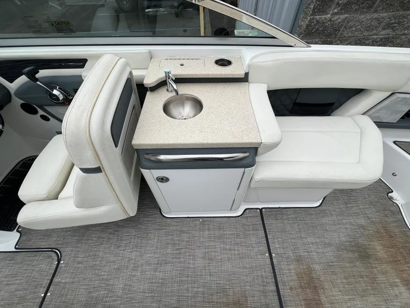 Slide: The Image of 2017 Cobalt A28 boat interior with sink and seating area. - 16