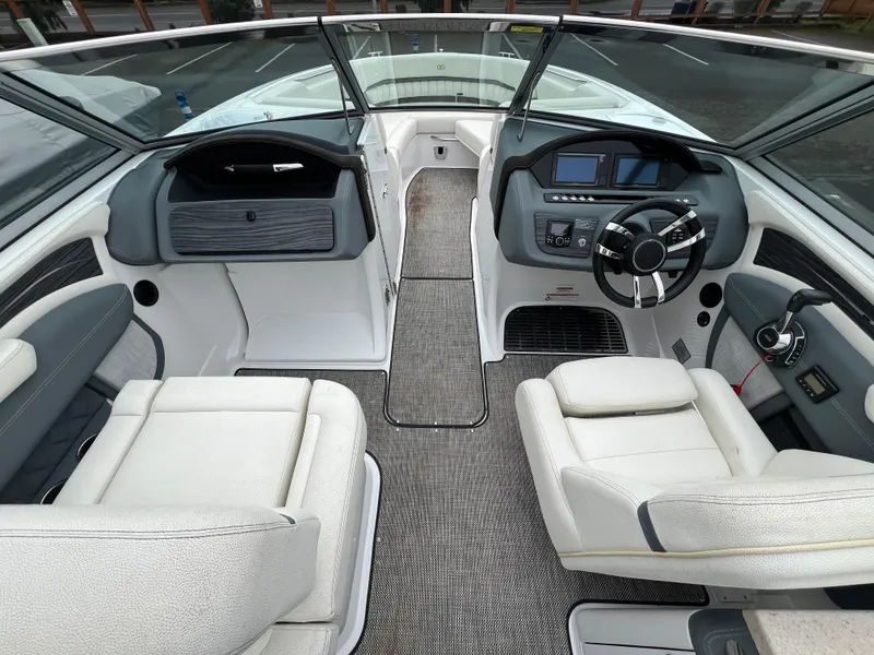 Slide: The Image of Interior of a 2017 Cobalt A28 boat with modern dashboard and seating. - 17