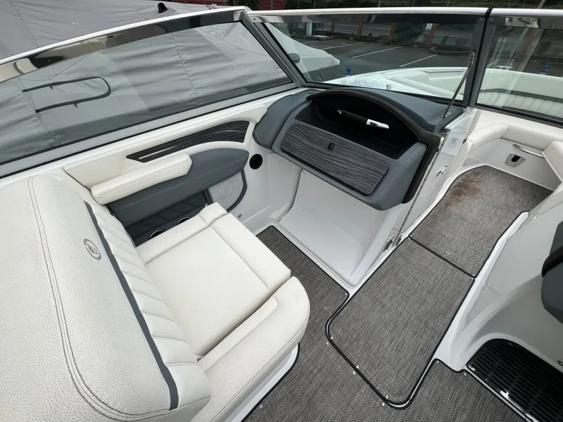 Slide: The Image of 2017 Cobalt A28 boat interior with white seating and gray flooring. - 18