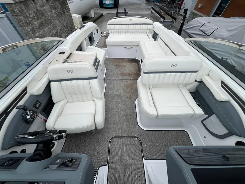 Slide: The Image of 2017 Cobalt A28 boat interior with white seating and modern dashboard. - 22