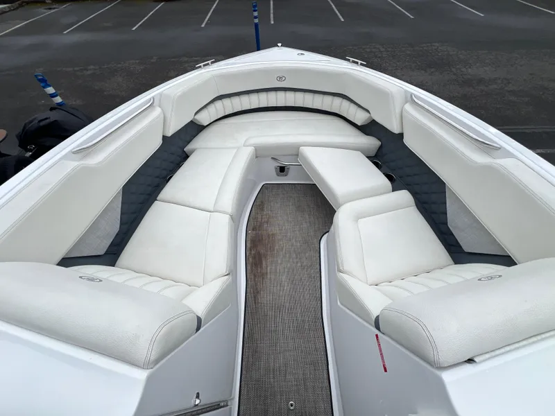 Slide: The Image of Luxurious seating on a 2017 Cobalt A28 boat, featuring white upholstery and spacious design. - 23