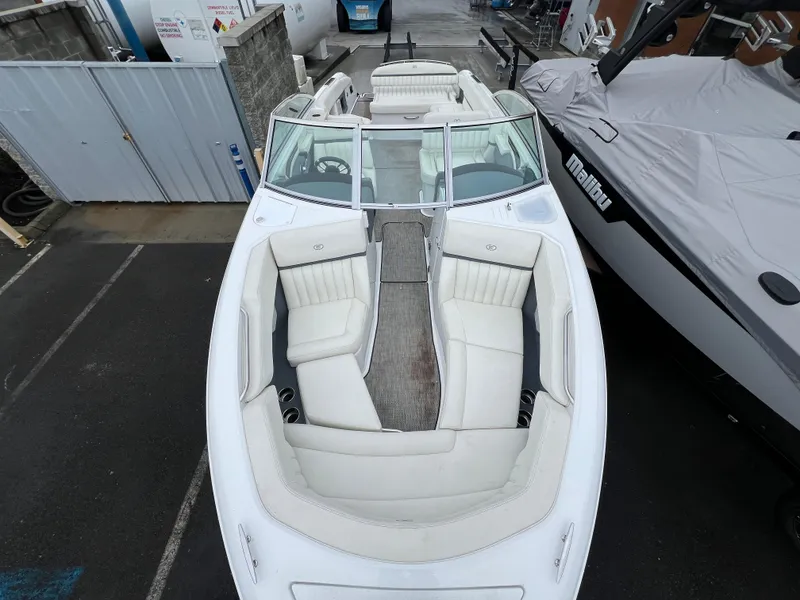 Slide: The Image of 2017 Cobalt A28 boat with white interior, docked beside a covered vessel. - 24