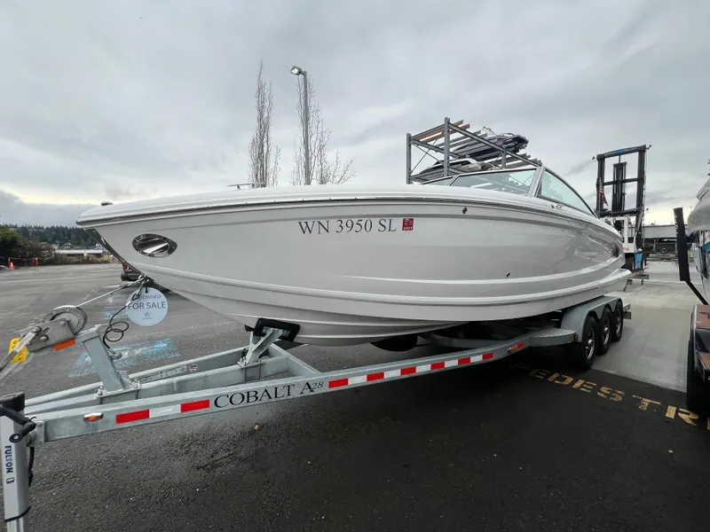 Slide: The Image of 2017 Cobalt A28 boat on trailer, for sale, parked outdoors. - 6