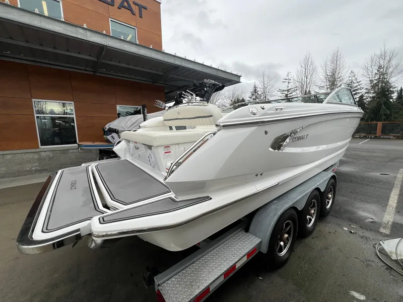 Slide: The Image of 2017 Cobalt A28 boat on trailer, parked outside dealership on a cloudy day. - 9