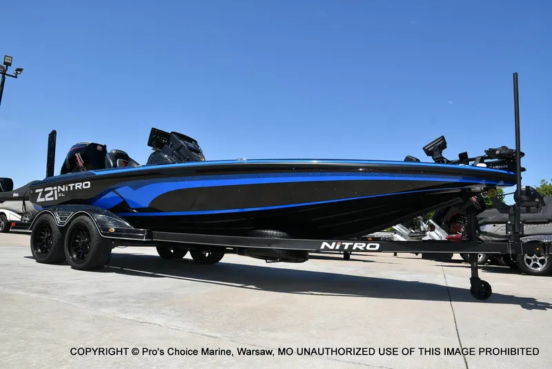 Slide: The Image of 2024 Nitro Z21 XL Pro Pack boat on trailer, blue and black design. - 11