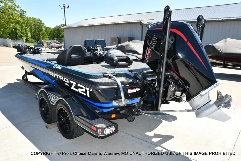 Slide: The Image of 2024 Nitro Z21 XL Pro Pack boat with powerful engine, parked outdoors. - 23