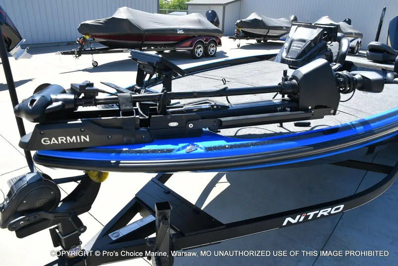 Slide: The Image of 2024 Nitro Z21 XL Pro Pack boat with Garmin equipment, displayed outdoors. - 26