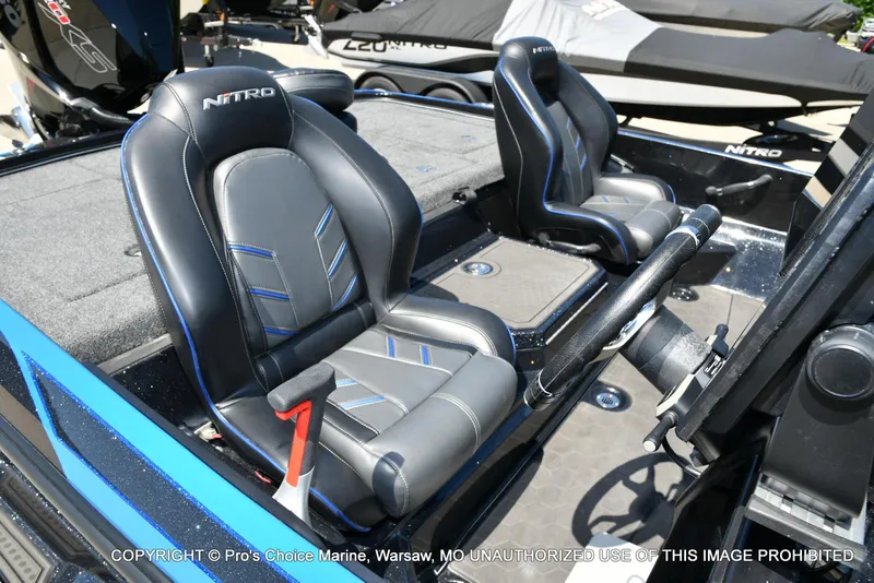Slide: The Image of 2024 Nitro Z21 XL Pro Pack boat interior with sleek black and blue seating. - 35