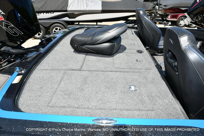 Slide: The Image of 2024 Nitro Z21 XL Pro Pack boat interior with gray carpet and black seats. - 36
