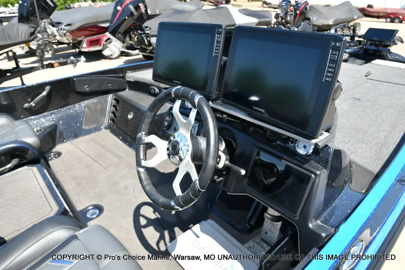 Slide: The Image of 2024 Nitro Z21 XL Pro Pack boat dashboard with dual Garmin displays and steering wheel. - 37