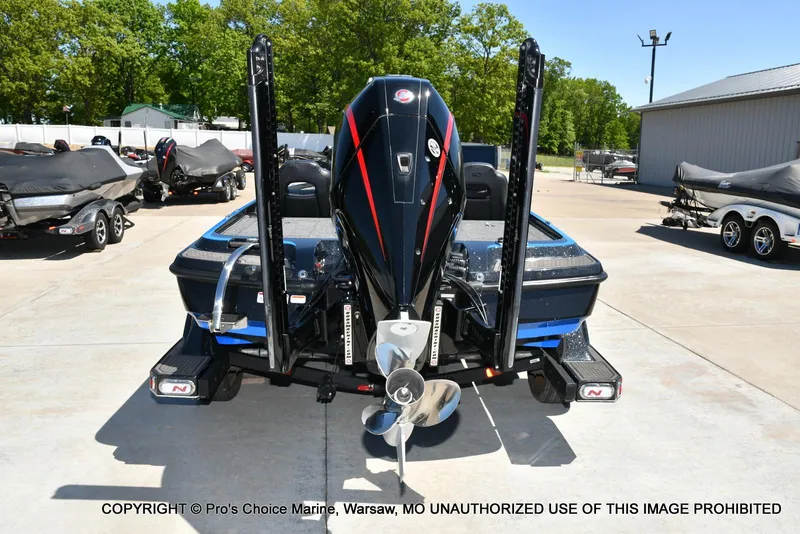 Slide: The Image of 2024 Nitro Z21 XL Pro Pack boat, rear view, in a marina setting. - 5