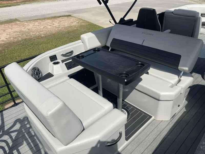 Slide: The Image of 2025 Sylvan G-3 DLZ DH boat interior with seating and table setup. - 13