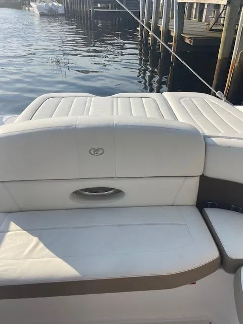 Slide: The Image of 2011 Cobalt 222 boat with white seating, docked by wooden piers. - 10