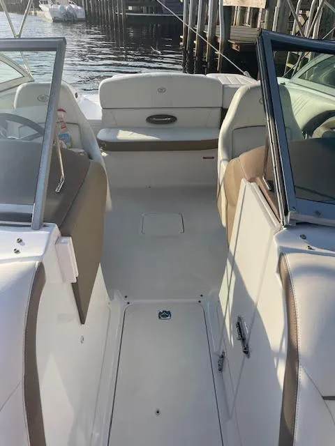Slide: The Image of 2011 Cobalt 222 boat interior with seating and open deck, docked by the water. - 16