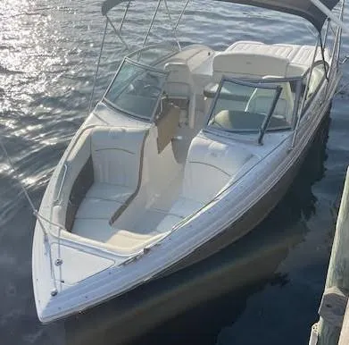 Slide: The Image of 2011 Cobalt 222 boat with white interior, docked on calm water. - 5