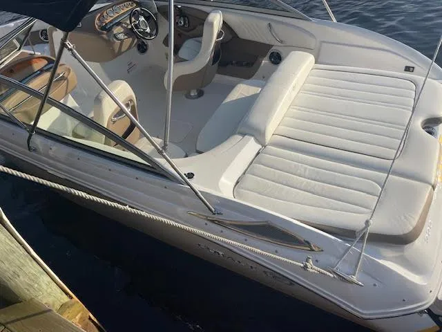 Slide: The Image of 2011 Cobalt 222 boat with white interior, docked on calm water. - 7