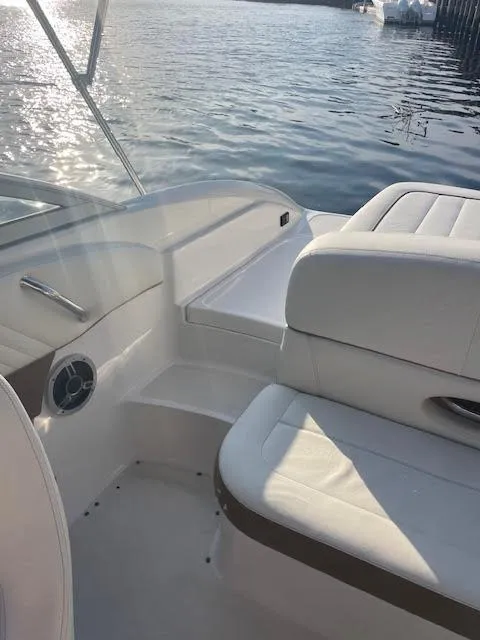 Slide: The Image of 2011 Cobalt 222 boat interior with white seating, near water. - 9