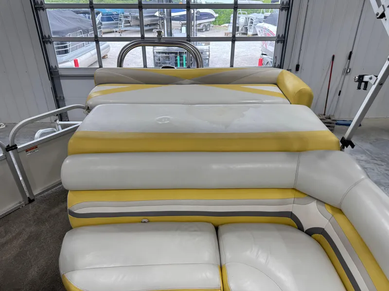 Slide: The Image of Landau 250 Atlantis 2010 boat interior with yellow and white seating in a garage. - 13