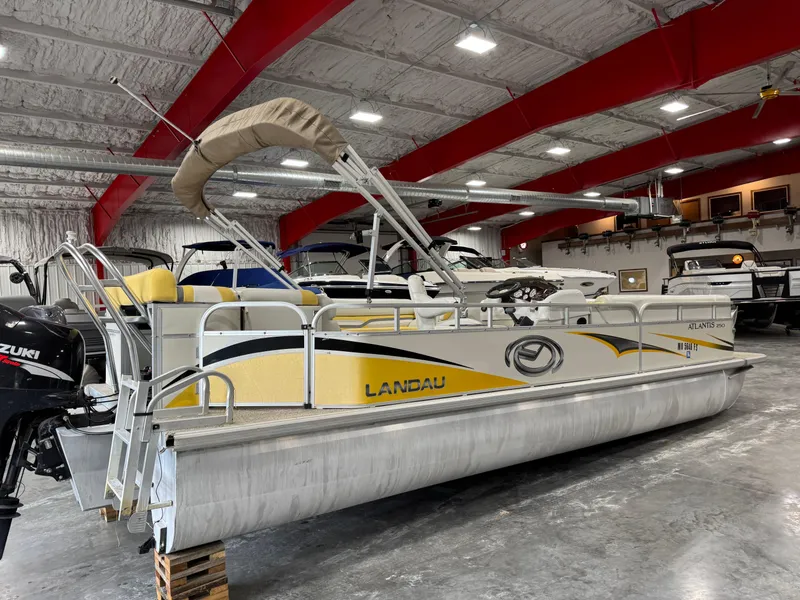 Slide: The Image of 2010 Landau 250 ATLANTIS pontoon boat in a spacious indoor showroom. - 3