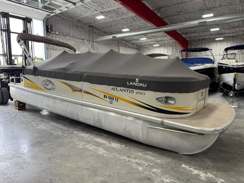 Slide: The Image of 2010 Landau 250 ATLANTIS pontoon boat with cover in indoor storage. - 6