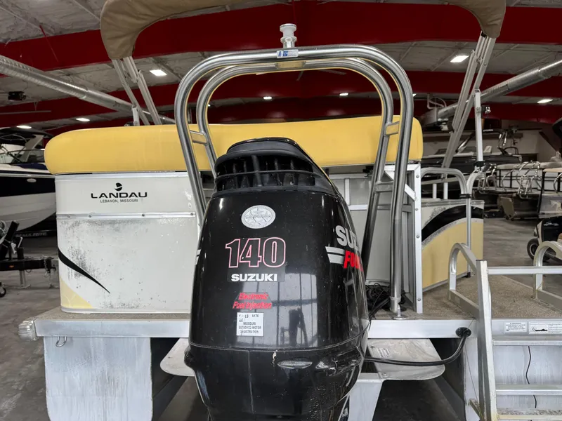 Slide: The Image of 2010 Landau 250 ATLANTIS boat with Suzuki 140 outboard motor in a showroom. - 7