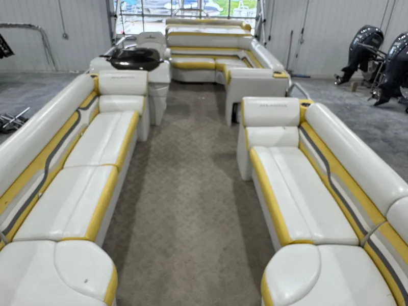 Slide: The Image of 2010 Landau 250 ATLANTIS boat interior with yellow and white seating in a spacious layout. - 8