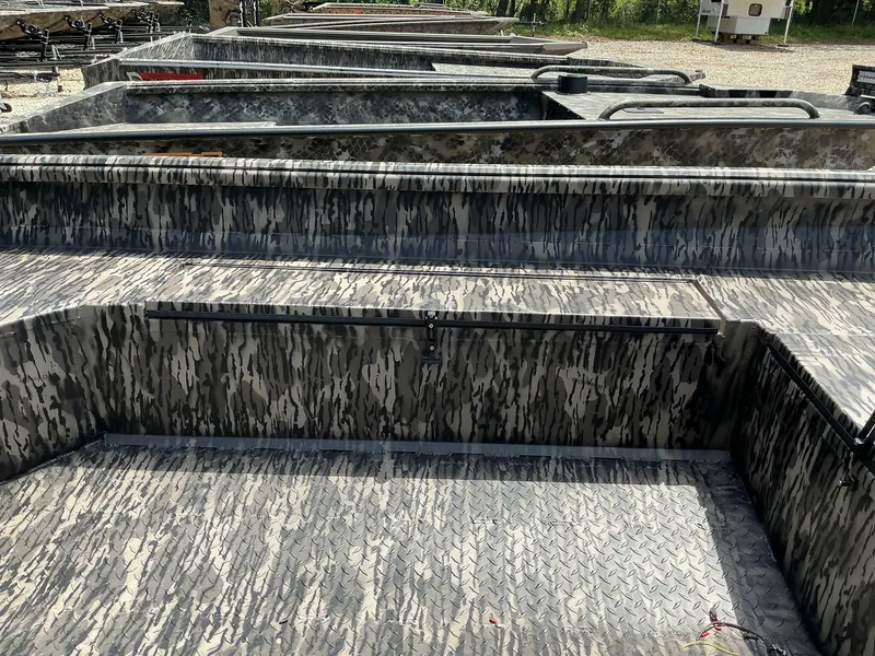 Slide: The Image of 2025 Reaper Boats 656 with camouflage pattern, parked outdoors. - 7