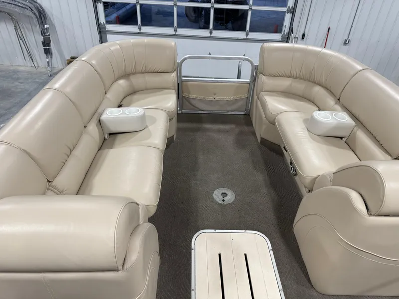 Slide: The Image of 2009 G3 25 ELITE pontoon boat interior with beige seating and cup holders. - 10