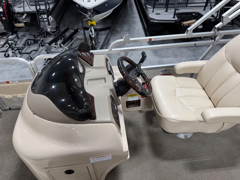 Slide: The Image of 2009 G3 25 ELITE boat cockpit with steering wheel and beige captain's chair. - 11