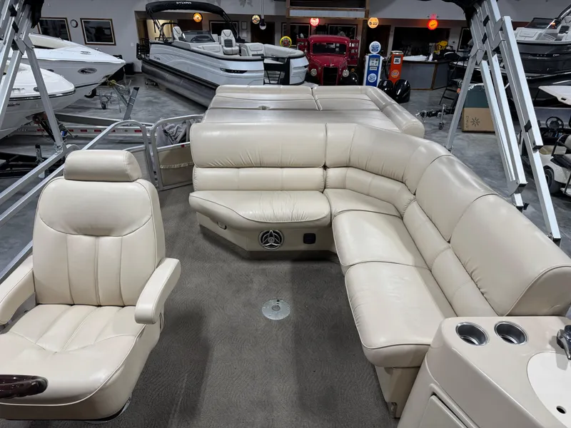 Slide: The Image of 2009 G3 25 ELITE pontoon boat interior with beige seating and carpeted floor. - 13