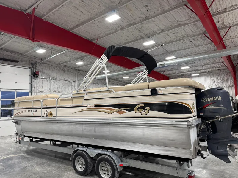 Slide: The Image of 2009 G3 25 ELITE pontoon boat on trailer in indoor storage facility. - 3