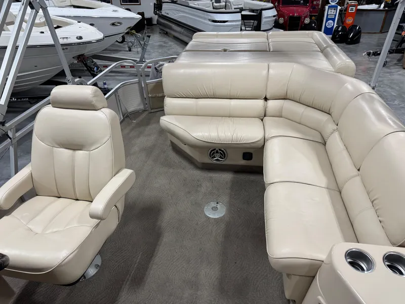 Slide: The Image of 2009 G3 25 ELITE boat interior with beige leather seating and captain's chair. - 9