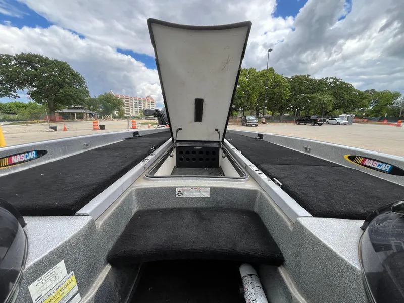 Slide: The Image of 2007 Ranger COMANCHE SERIES Z22 NASCAR boat with open storage compartment, parked outdoors. - 19