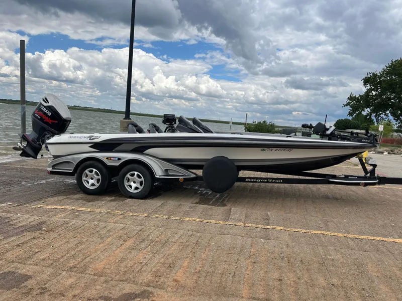 Slide: The Image of 2007 Ranger COMANCHE SERIES Z22 NASCAR boat on trailer by a lake. - 2