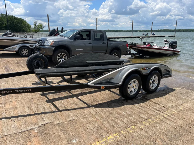 Slide: The Image of Trailer for 2007 Ranger COMANCHE SERIES Z22 NASCAR by a lake with boats and truck. - 33