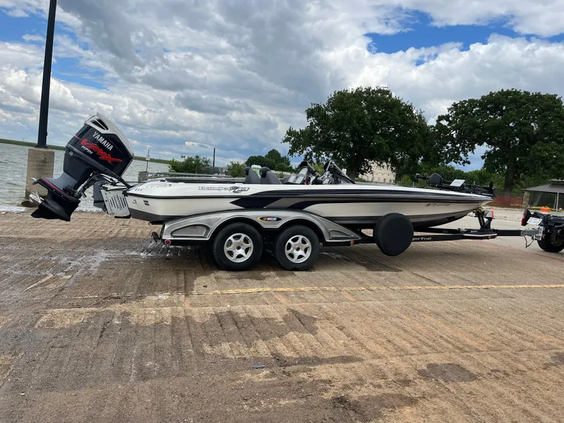Slide: The Image of 2007 Ranger COMANCHE SERIES Z22 NASCAR boat on trailer by the water. - 6