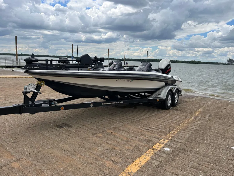 Slide: The Image of 2007 Ranger COMANCHE SERIES Z22 NASCAR boat on trailer by a lake under cloudy sky. - 8