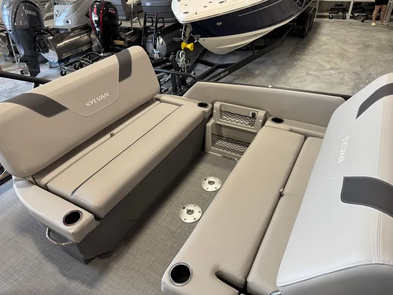 Slide: The Image of 2025 Sylvan L 5 boat interior with beige seating and cup holders. - 16