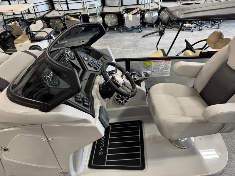 Slide: The Image of 2025 Sylvan L 5 boat cockpit with modern controls and comfortable seating. - 18