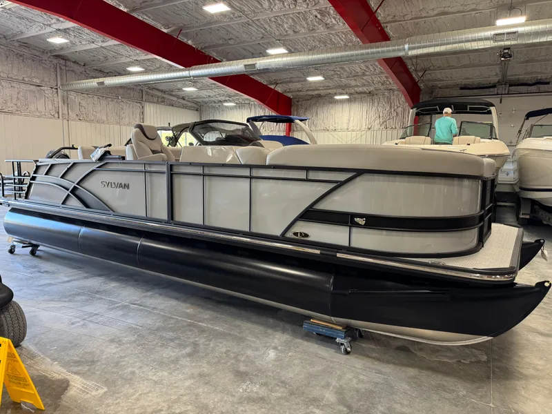 Slide: The Image of 2025 Sylvan L 5 pontoon boat in a showroom, featuring sleek design and modern amenities. - 20