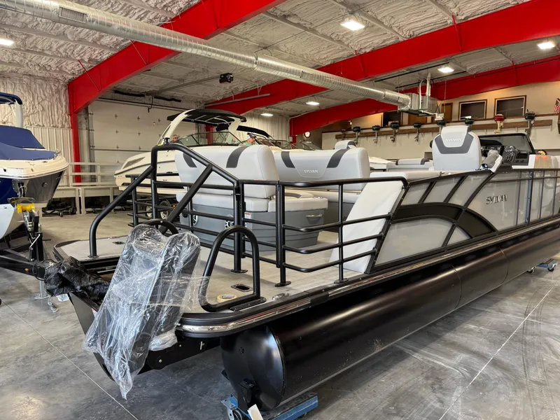 Slide: The Image of 2025 Sylvan L 5 pontoon boat in showroom, featuring sleek design and modern seating. - 21
