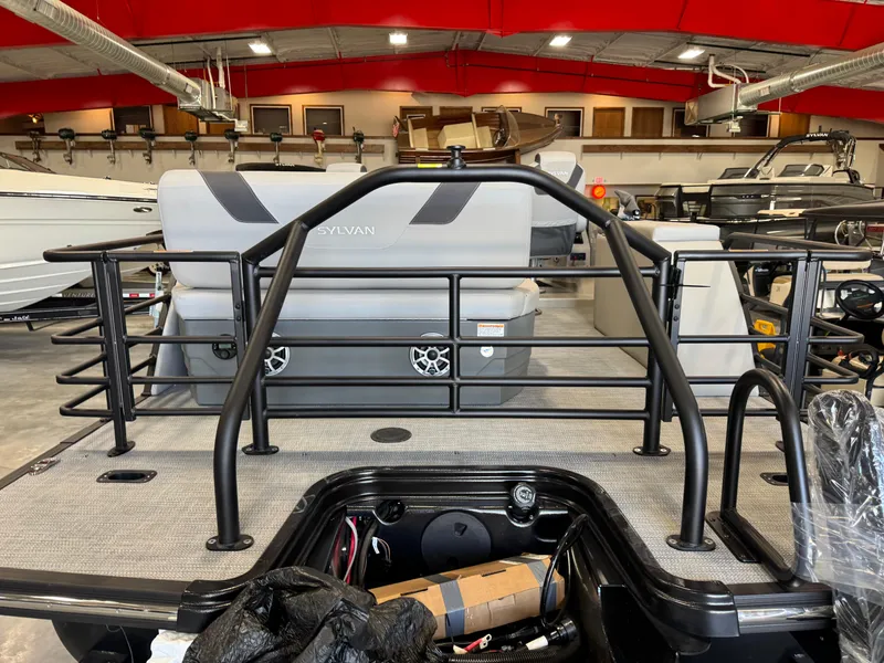 Slide: The Image of 2025 Sylvan L 5 boat interior with seating and railing in a showroom. - 22