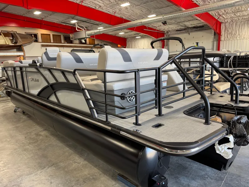 Slide: The Image of 2025 Sylvan L 5 pontoon boat in showroom, featuring sleek design and modern seating. - 23