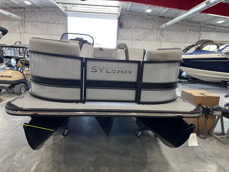 Slide: The Image of 2025 Sylvan L 5 pontoon boat in showroom, rear view. - 25