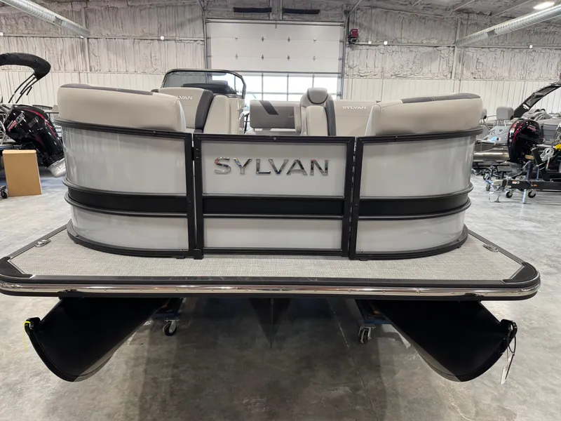 Slide: The Image of 2025 Sylvan L 5 pontoon boat in a showroom, rear view with seating. - 5