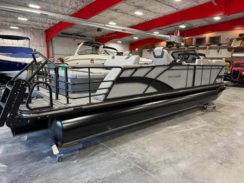Slide: The Image of 2025 Sylvan L 5 pontoon boat in showroom with sleek design and modern features. - 6