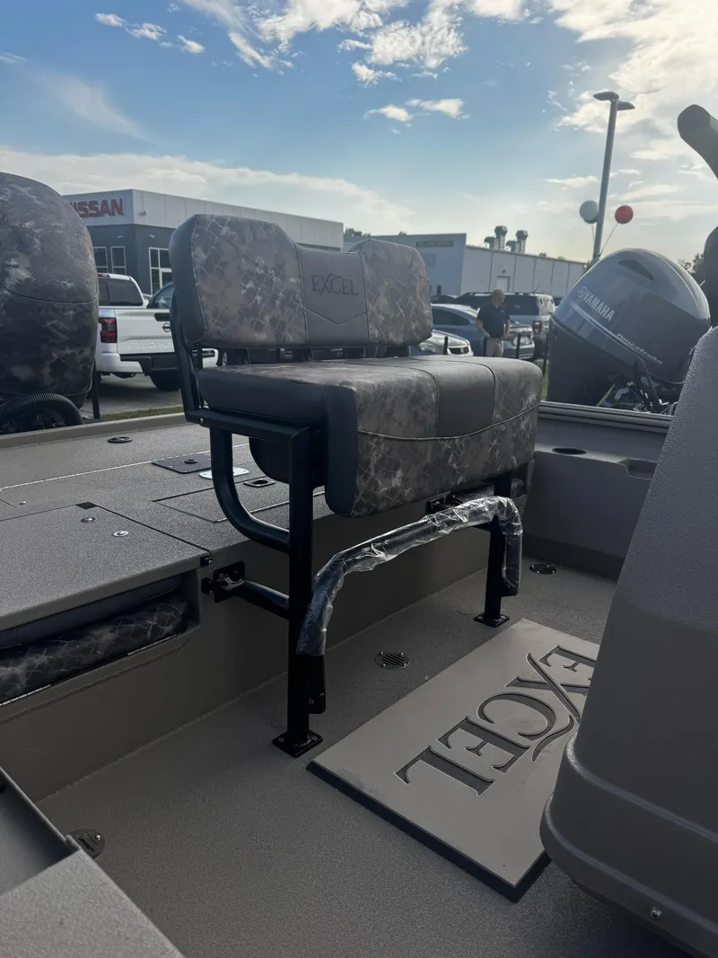 Slide: The Image of 2025 Excel BAY PRO 230 ELITE boat interior with camo seating and Yamaha engine. - 3